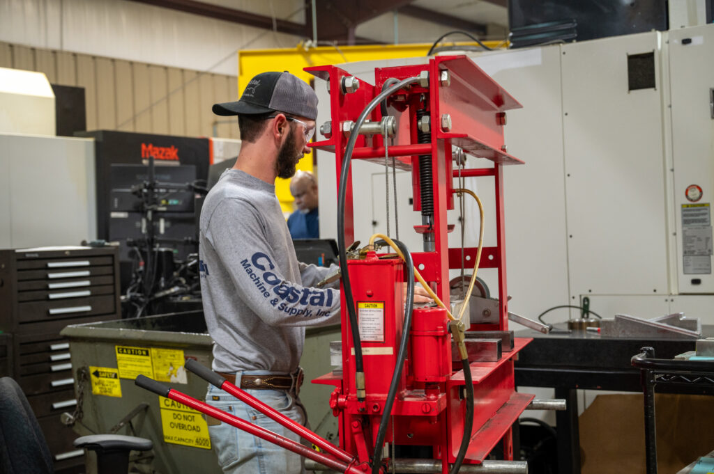 Machinist performing a quality check on finished sheet metal part