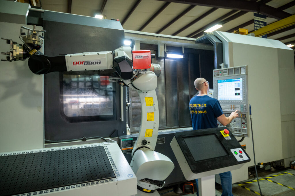 CNC Operator working on a large part machining mill