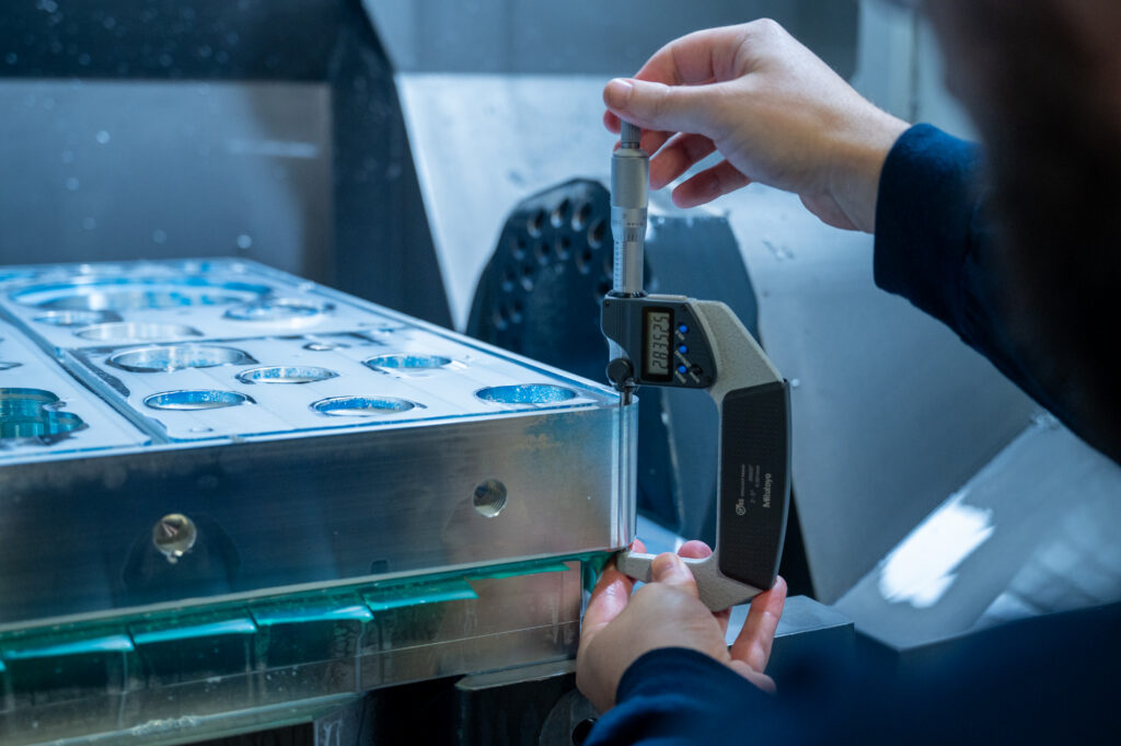Machinist examining a sheet metal part during production