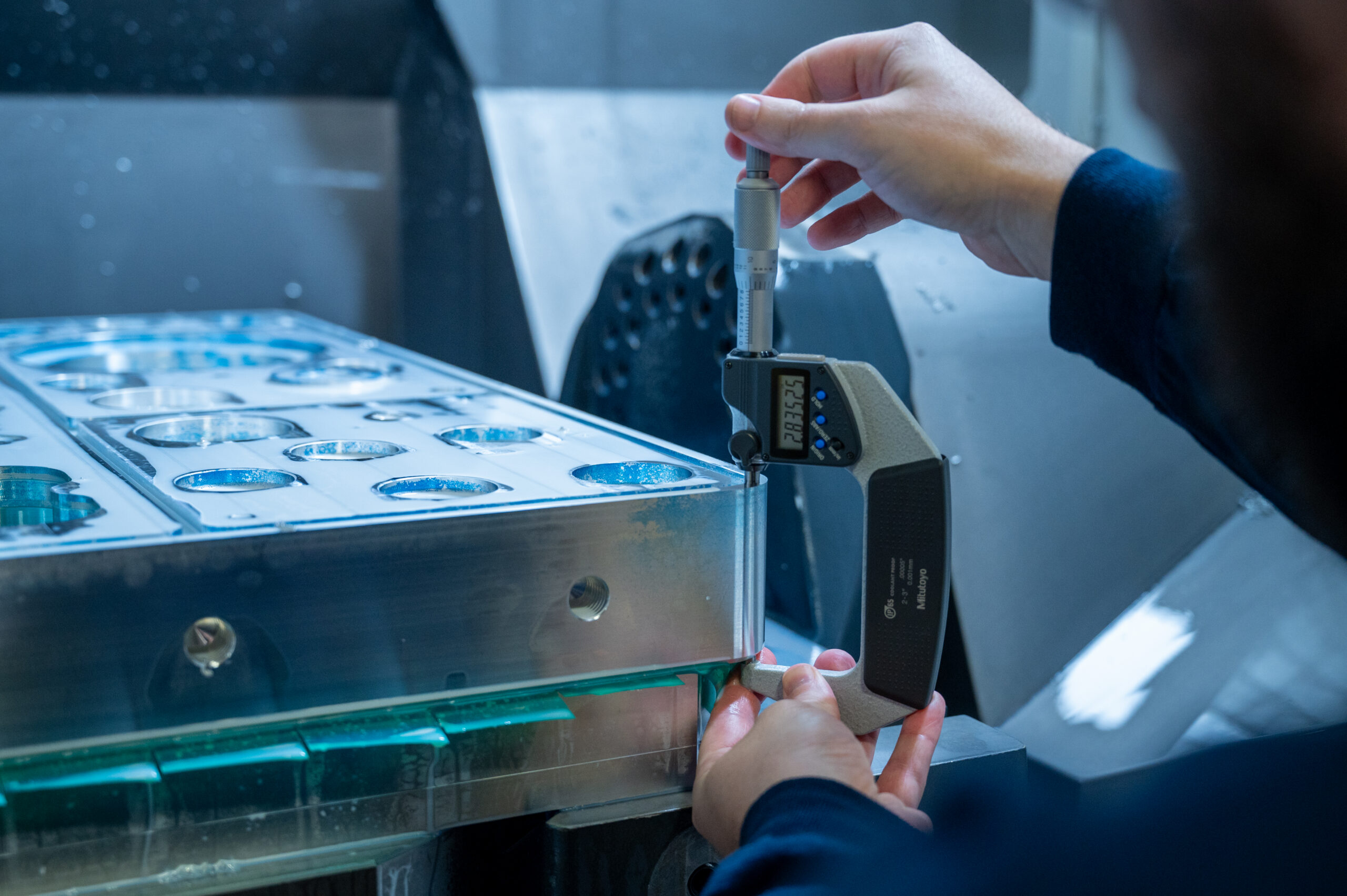 Machinist examining a sheet metal part during production