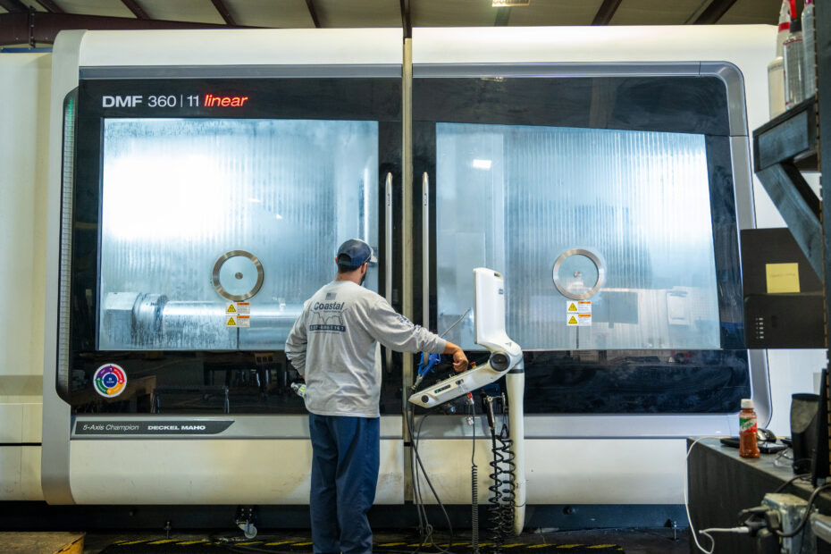 CNC Operator running an operation on a Mazak DMF 360 11 linear